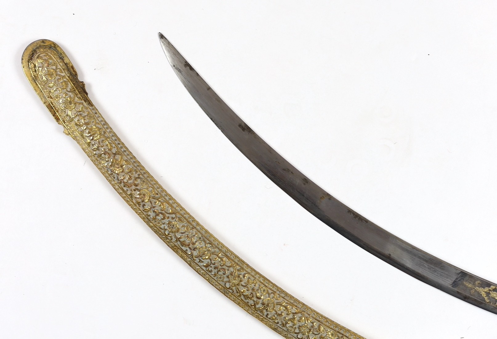 A fine Indian gilt copper and paste mounted sword (shamshir), Kutch, 19th century, sword 79cm long, scabbard 75cm long